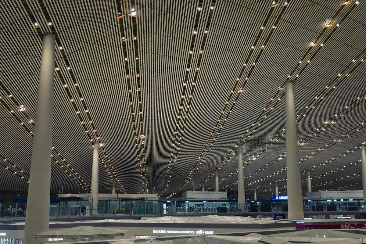 A modern Chinese airport terminal with a striking ceiling design