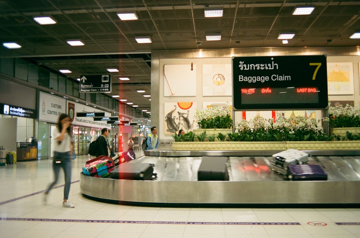Travelers walking through an airport terminal