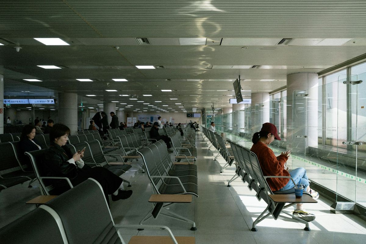 Passengers waiting at an airport gate