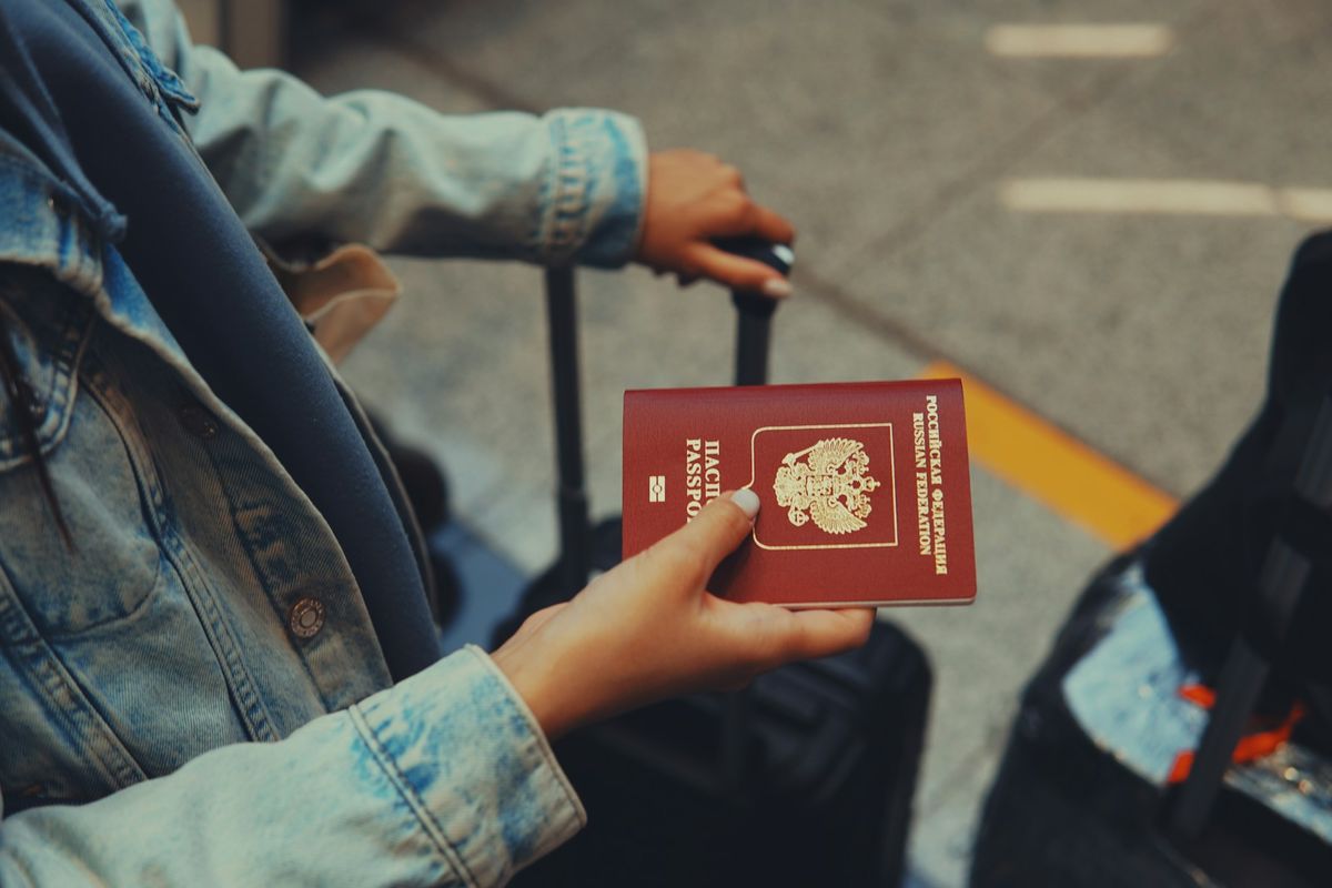 Person holding red passport at airport