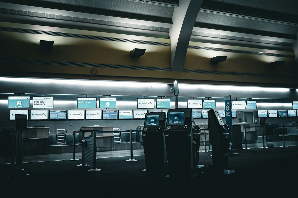 Airport terminal with illuminated check-in and passport control counters