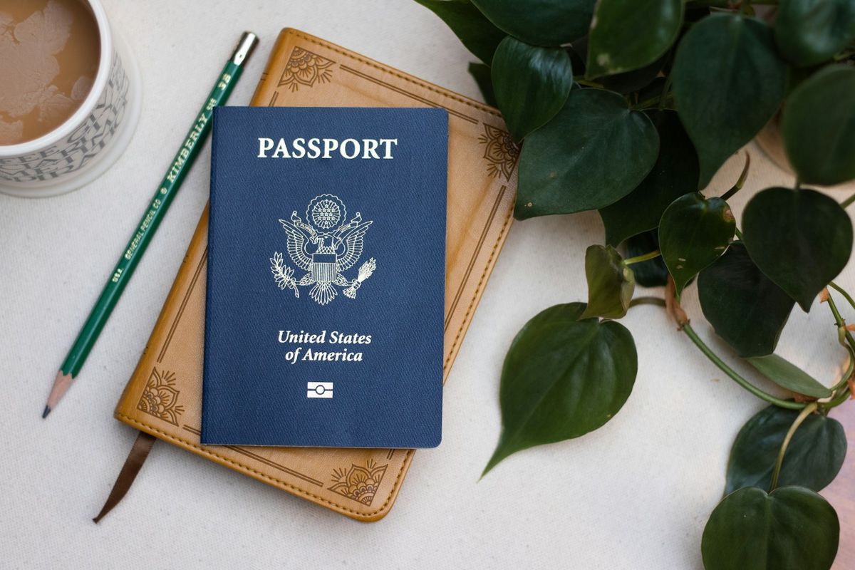 Passport on a table next to a cup of coffee