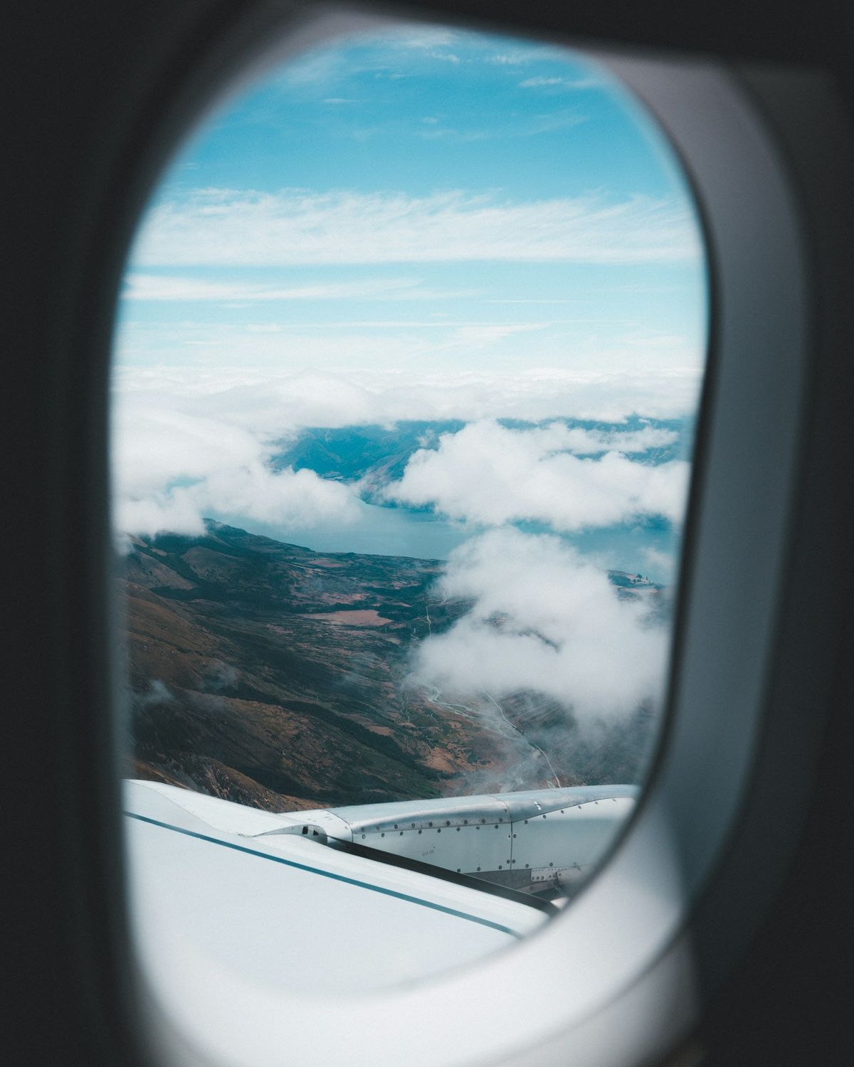 Aerial view of mountains and clouds seen from an airplane on approach