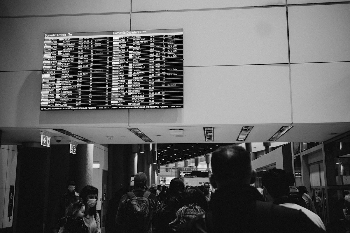 Travellers in an airport terminal hall