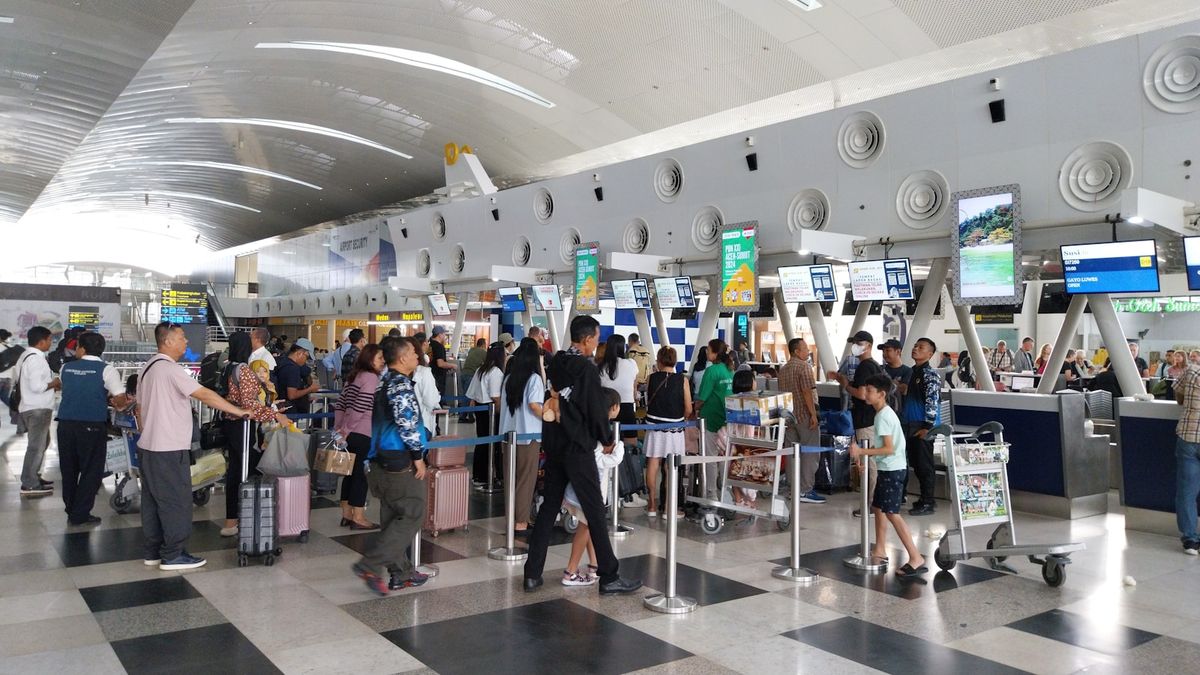 Travelers waiting in line at an airport check-in area