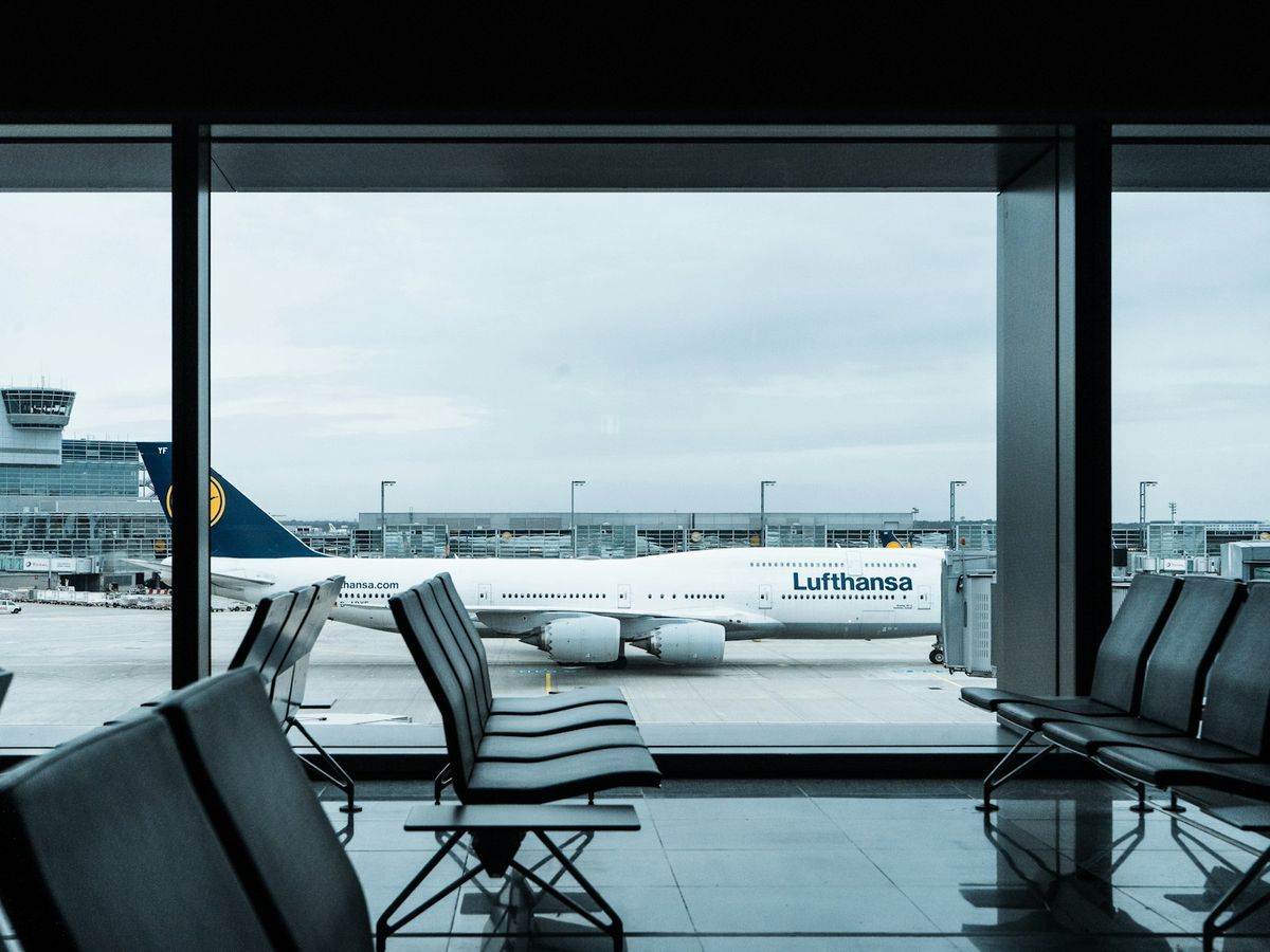 Empty airport gate seating area with a view of the tarmac