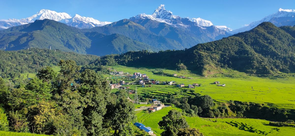 Green valley with Himalaya mountains in background Nepal