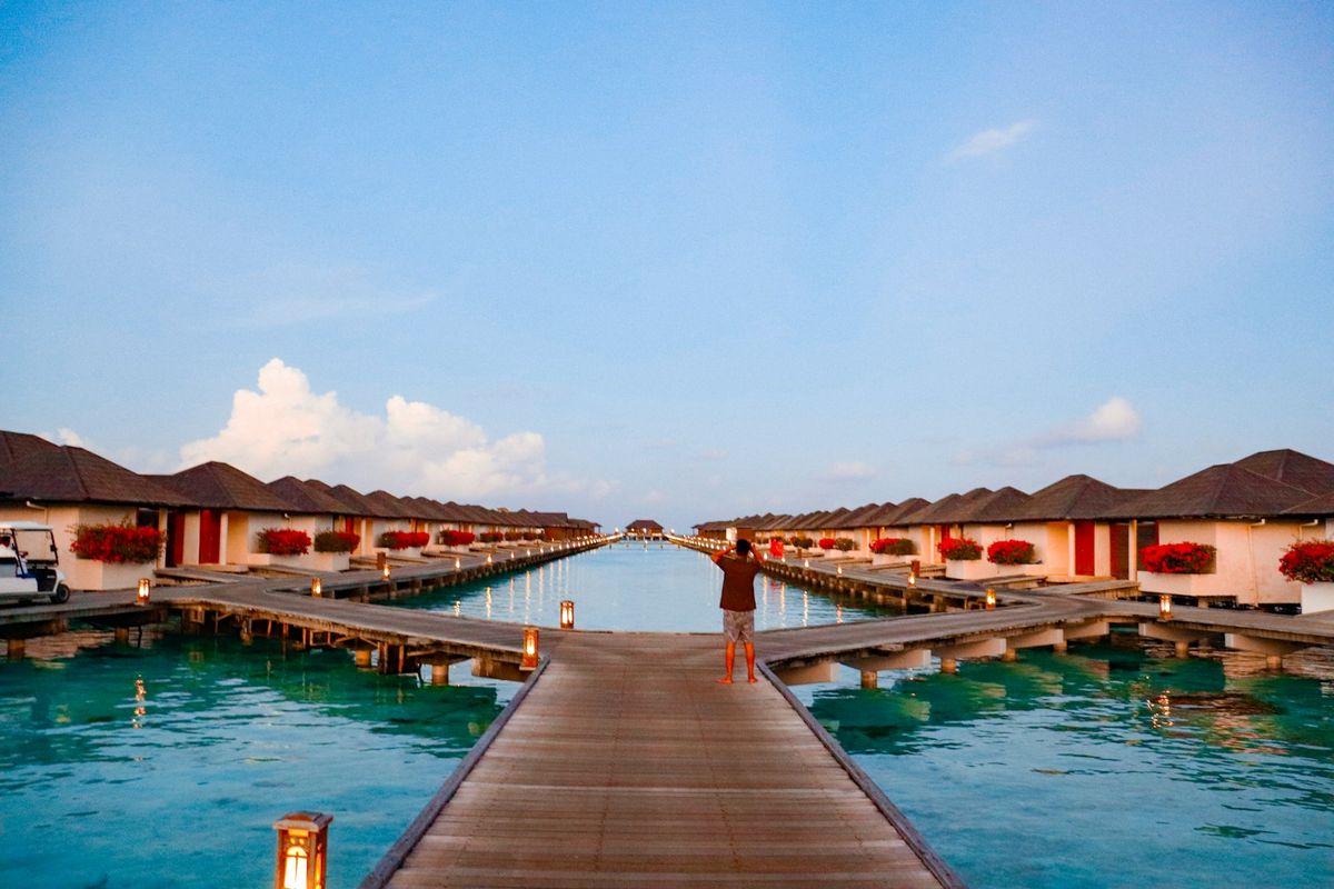 Overwater bungalows on a turquoise lagoon in the South Pacific