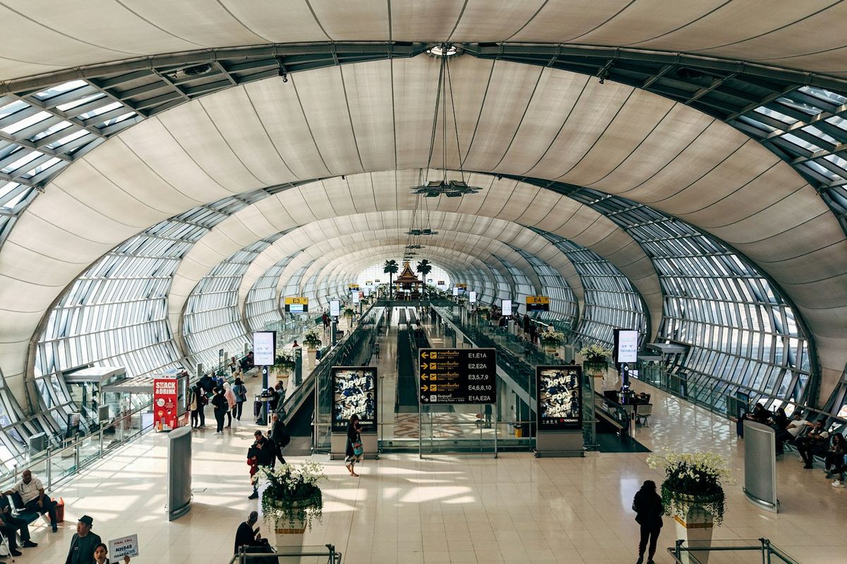 People walking inside Bangkok airport terminal