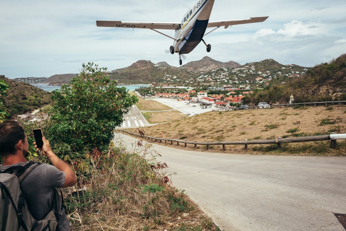 A small plane landing at a Caribbean island airport