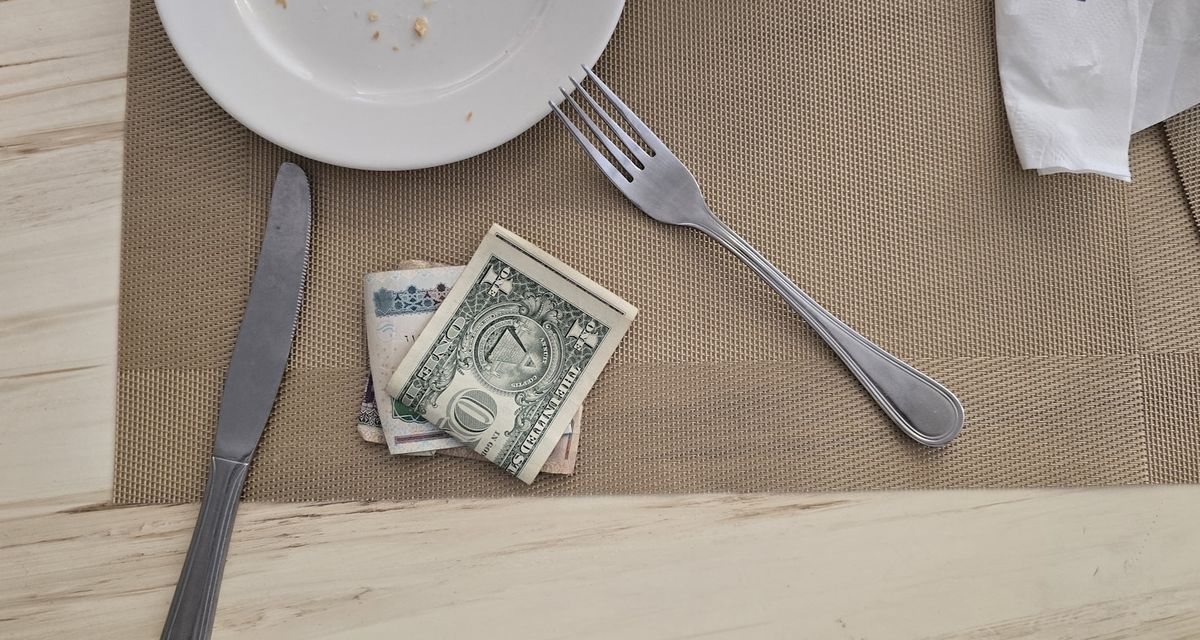 Cash left on a restaurant table as a tip after a meal