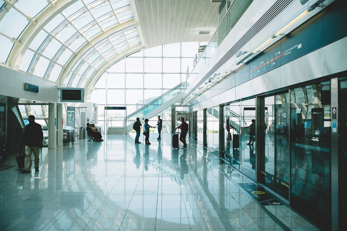 Passengers walking through a modern airport terminal