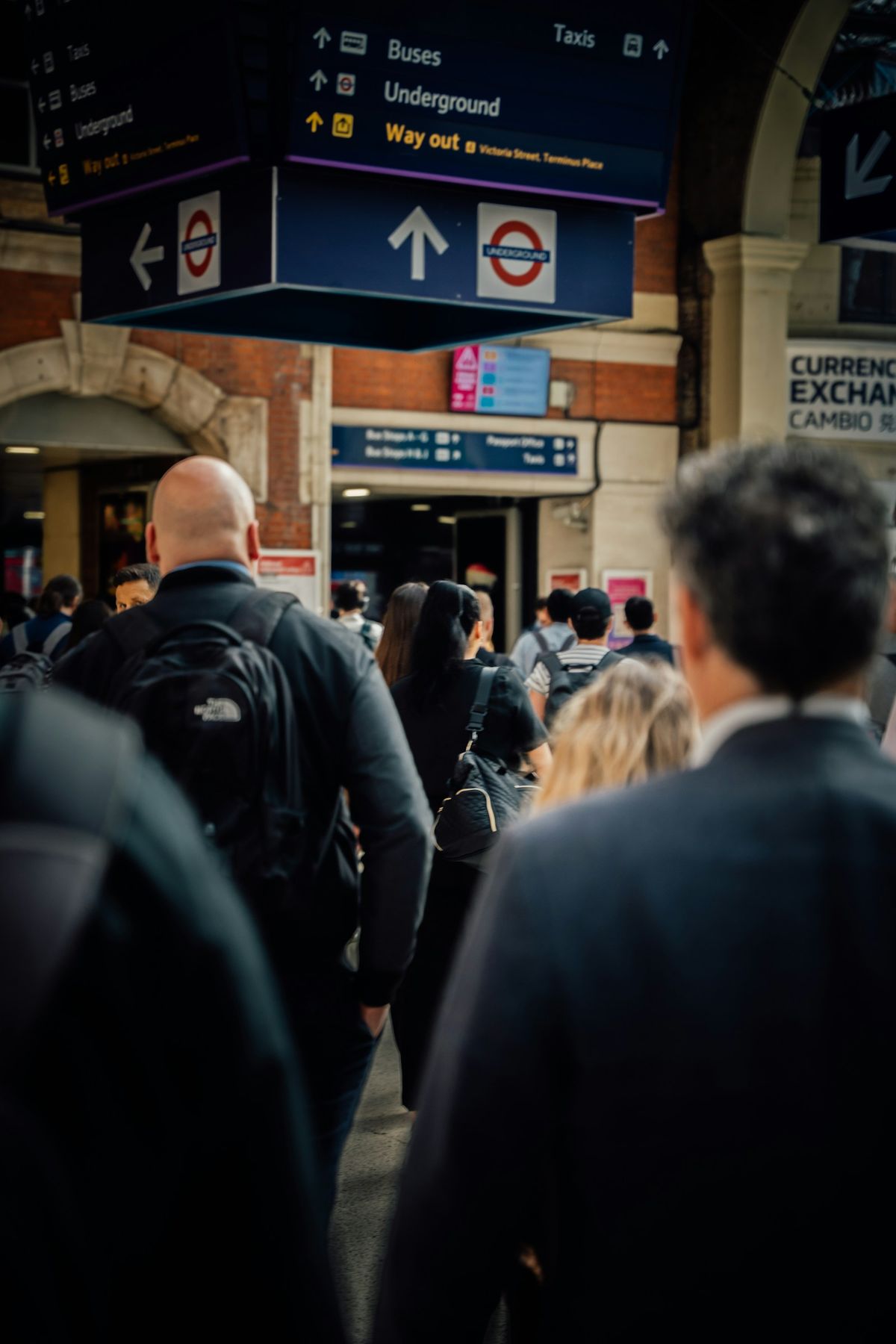 Travellers walking through a busy UK train station