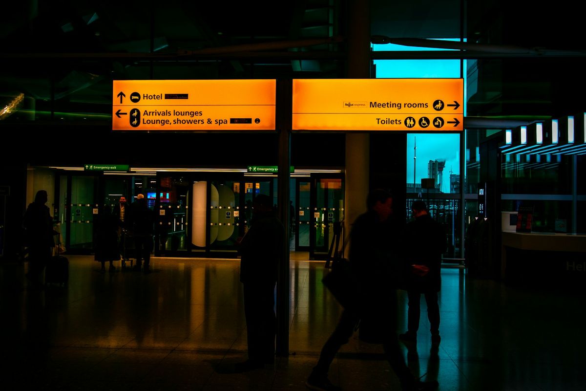 Travellers walking through an airport arrivals terminal in the UK