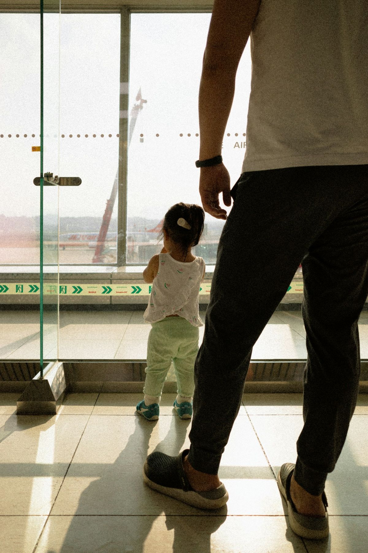 A child watching aircraft at the airport before a flight