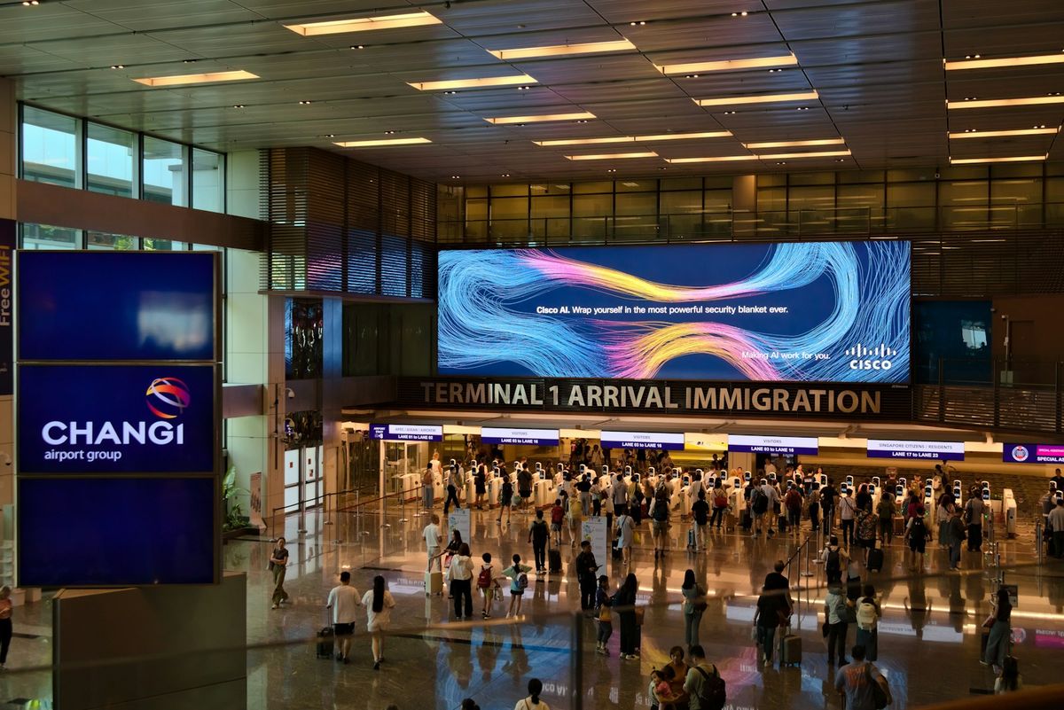 Travellers walking through an airport arrivals terminal