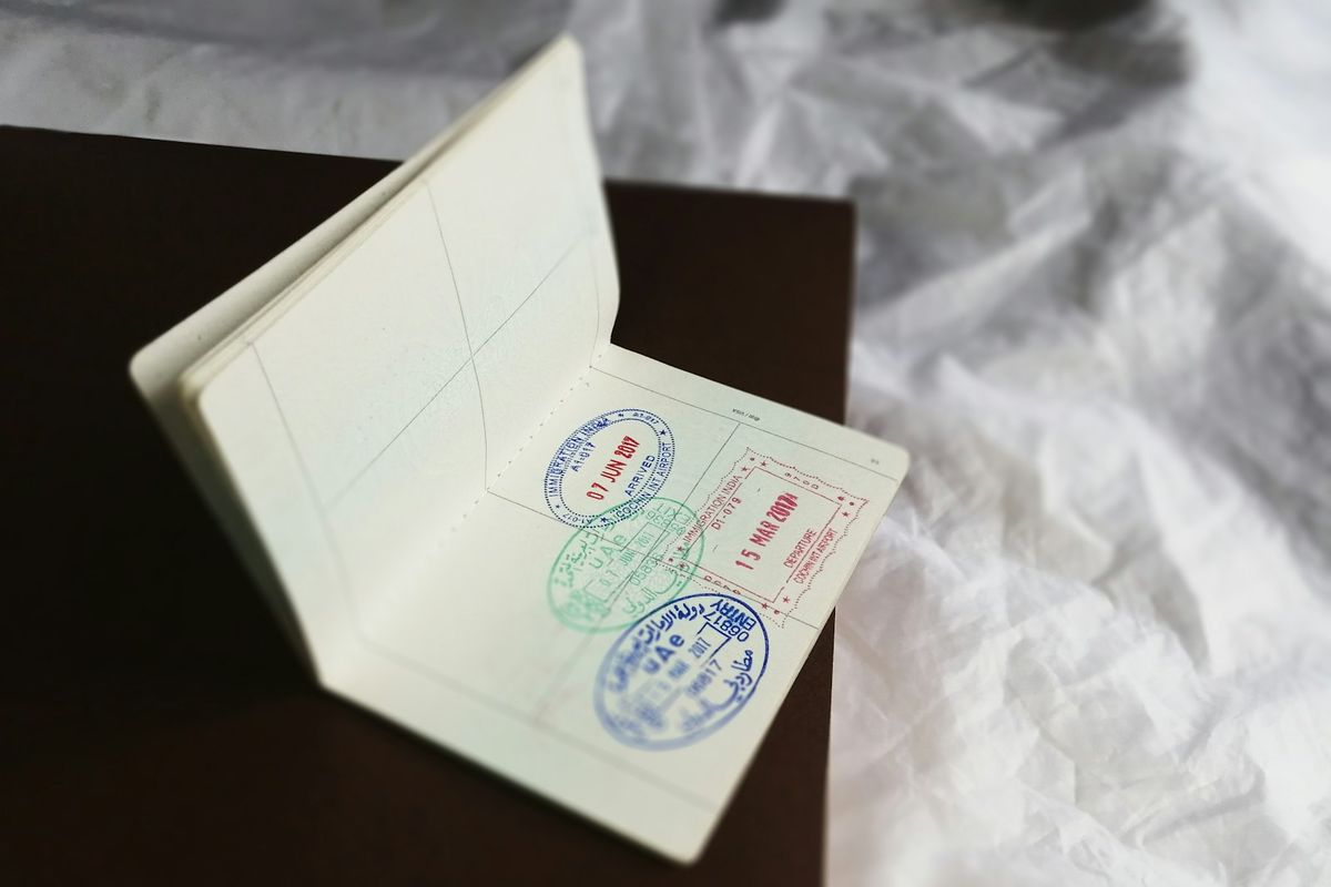 Close-up of a passport page covered in visa entry stamps