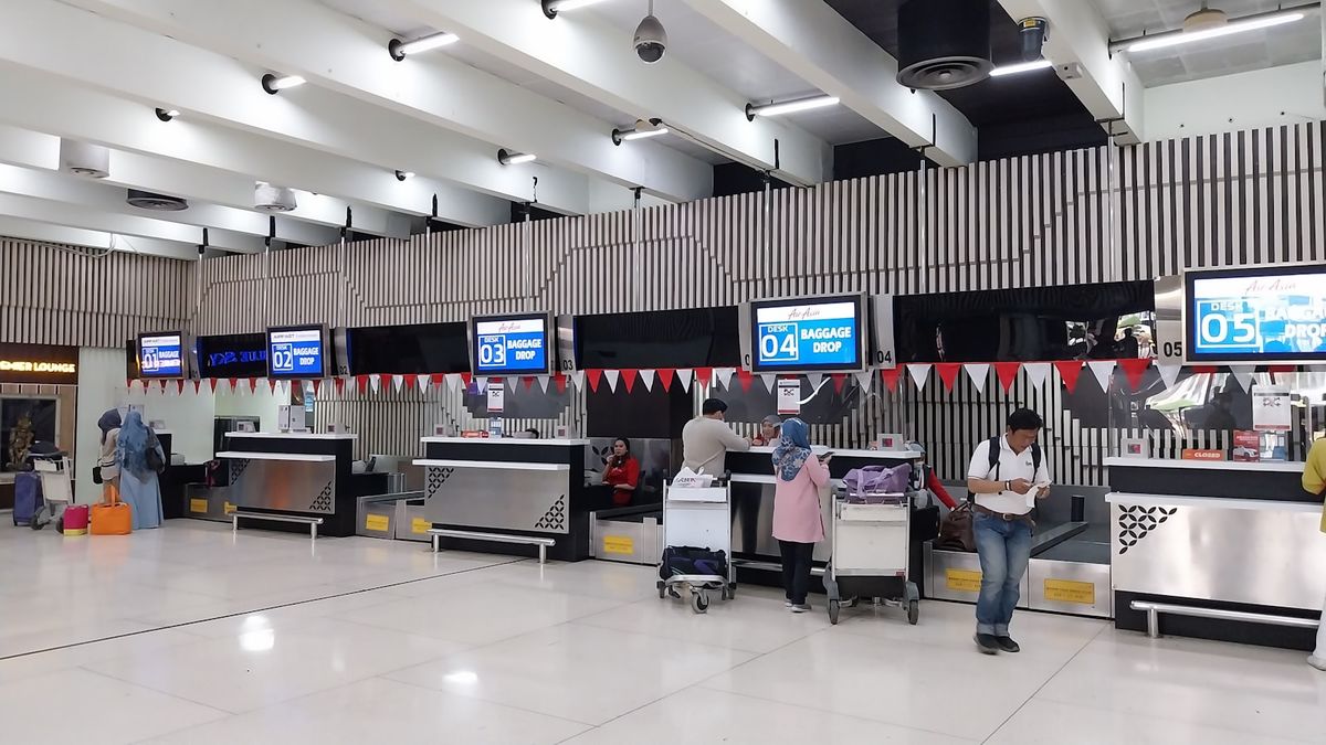 Travelers queuing at an airport passport control area