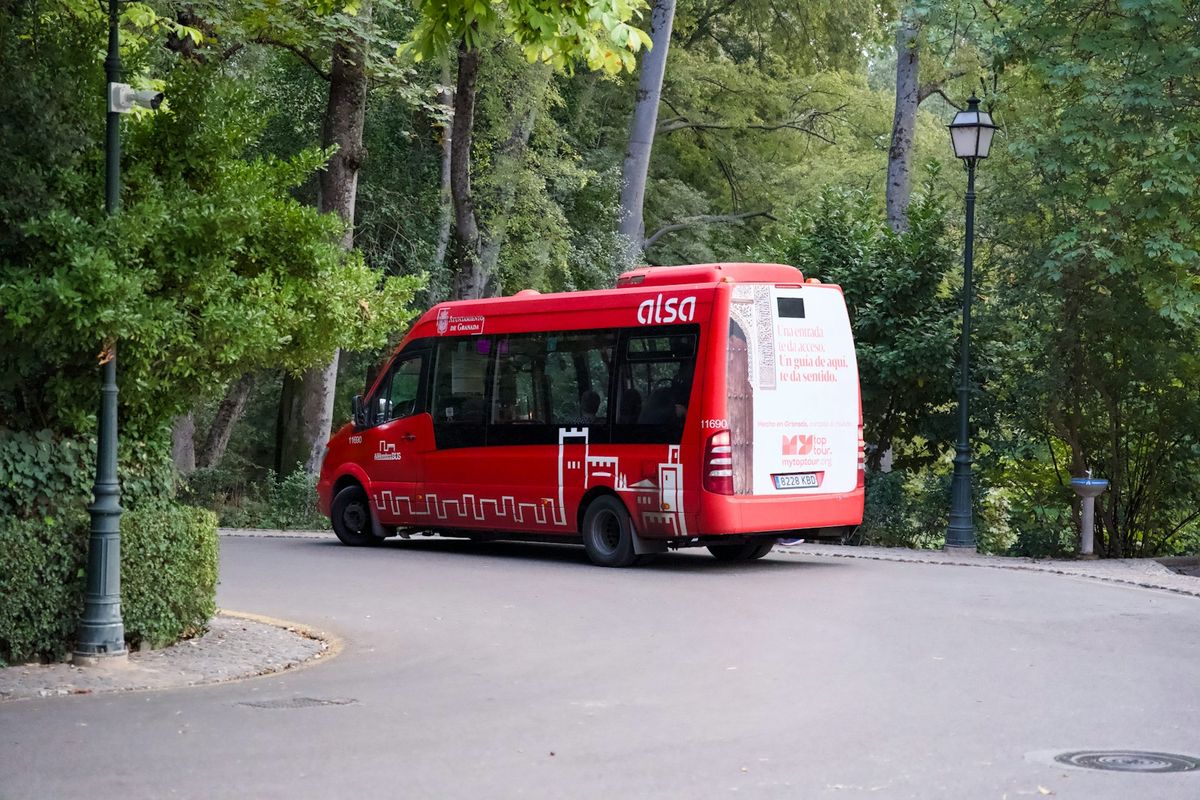 Coach bus on a road through trees in Spain