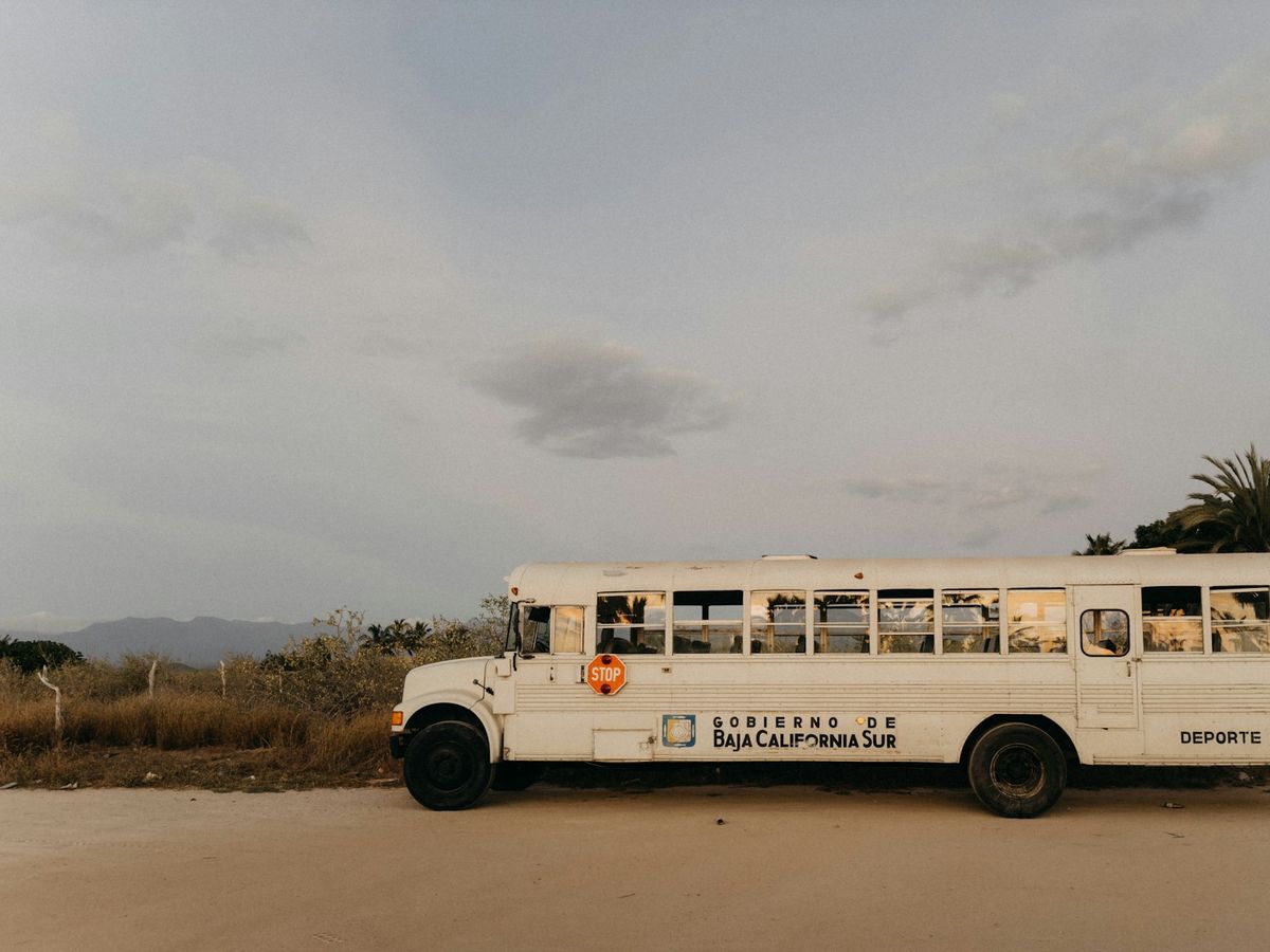 Bus parked in a coastal desert landscape in Baja California, Mexico