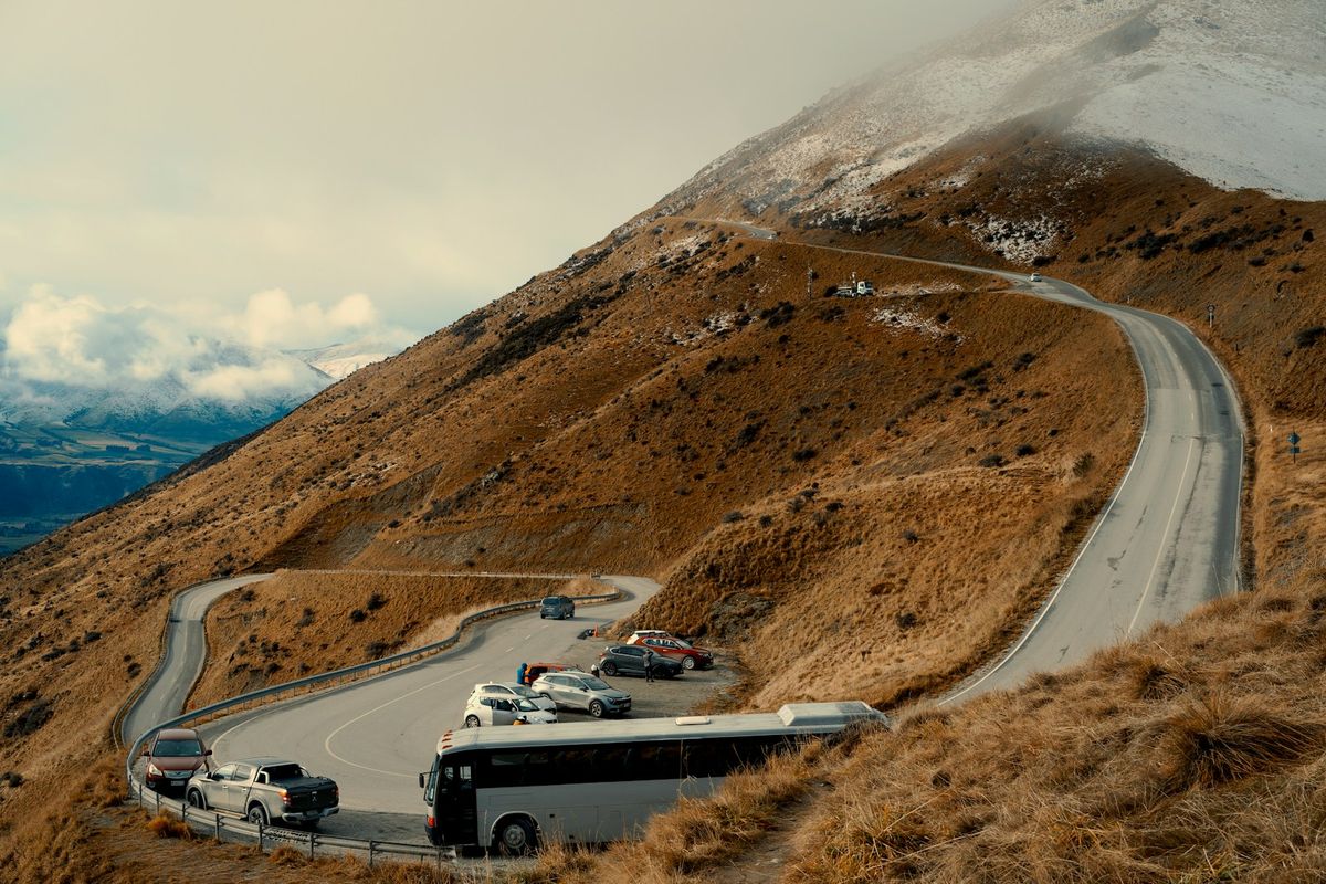 Coach bus driving along a winding mountain road