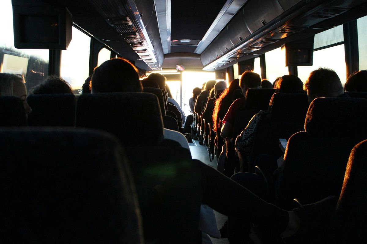 People riding a passenger bus during daytime