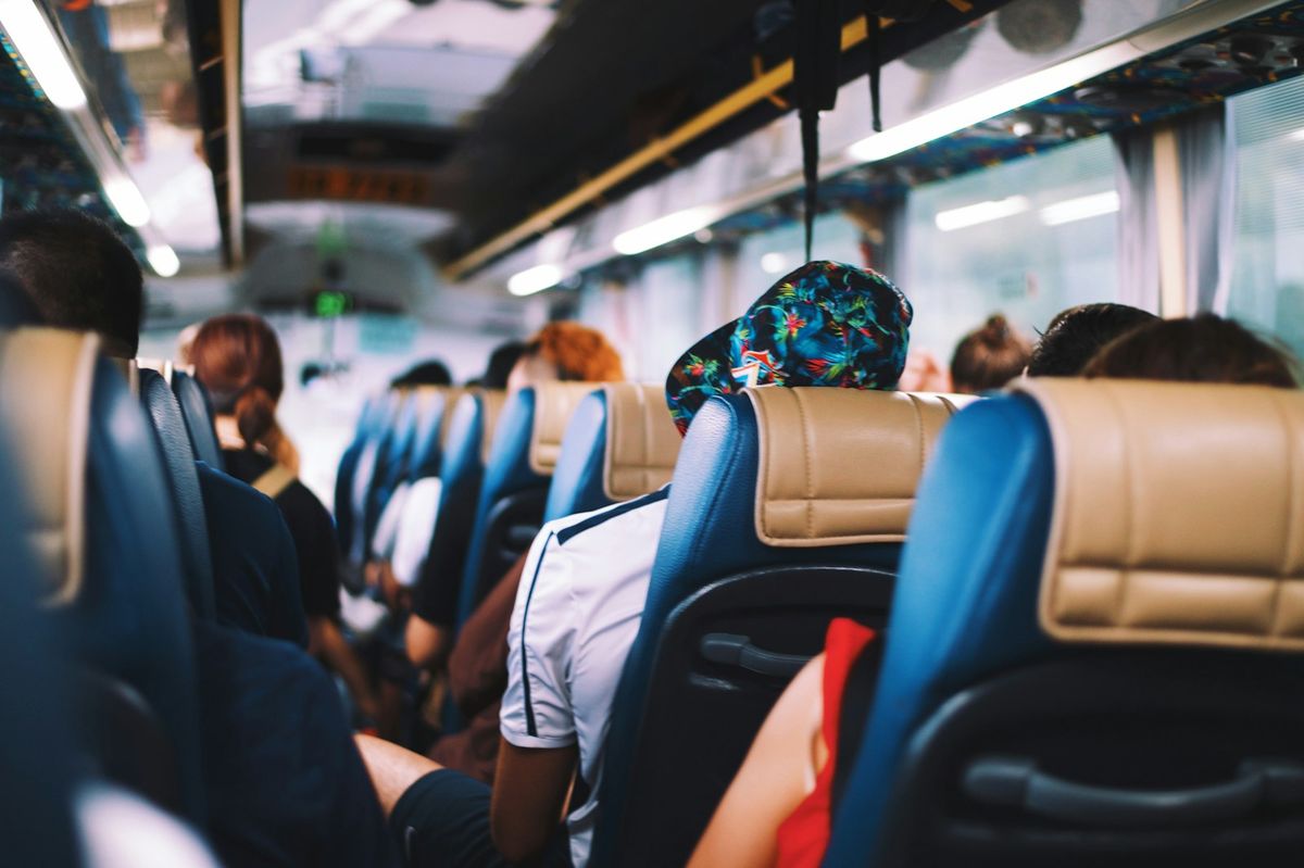 Travellers seated on a passenger bus during daytime