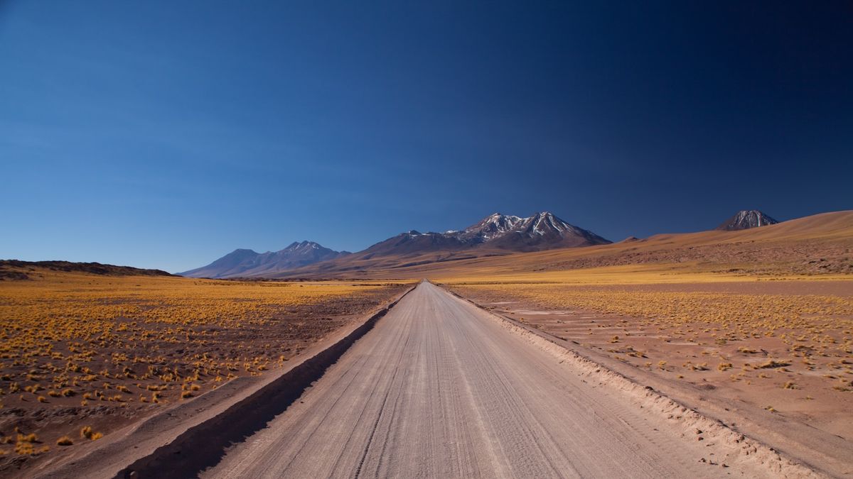 Brown desert road under blue sky, Atacama, Chile