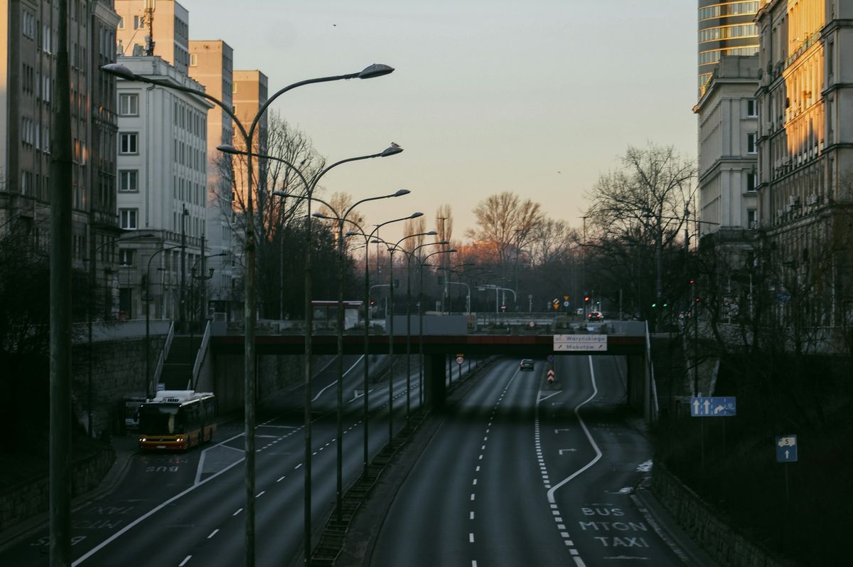 City street with bus and overpass at sunset in Eastern Europe