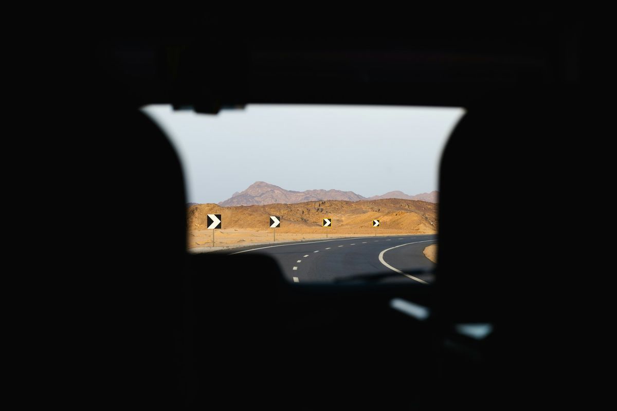 View of a desert highway from inside a vehicle in Egypt