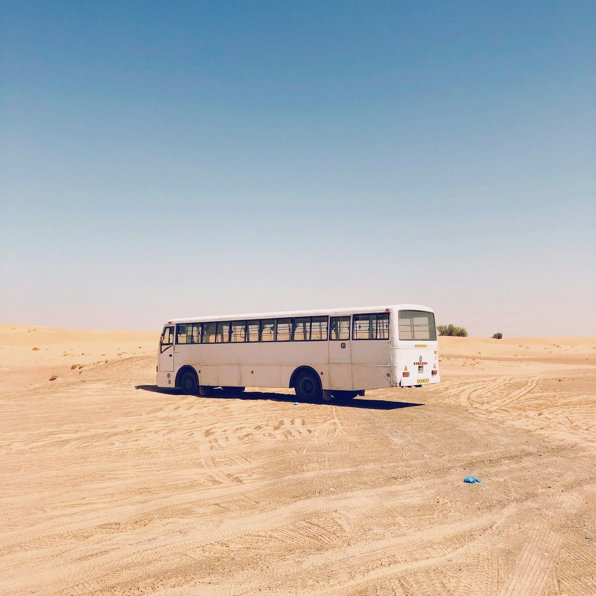 White intercity bus on a desert road in Morocco