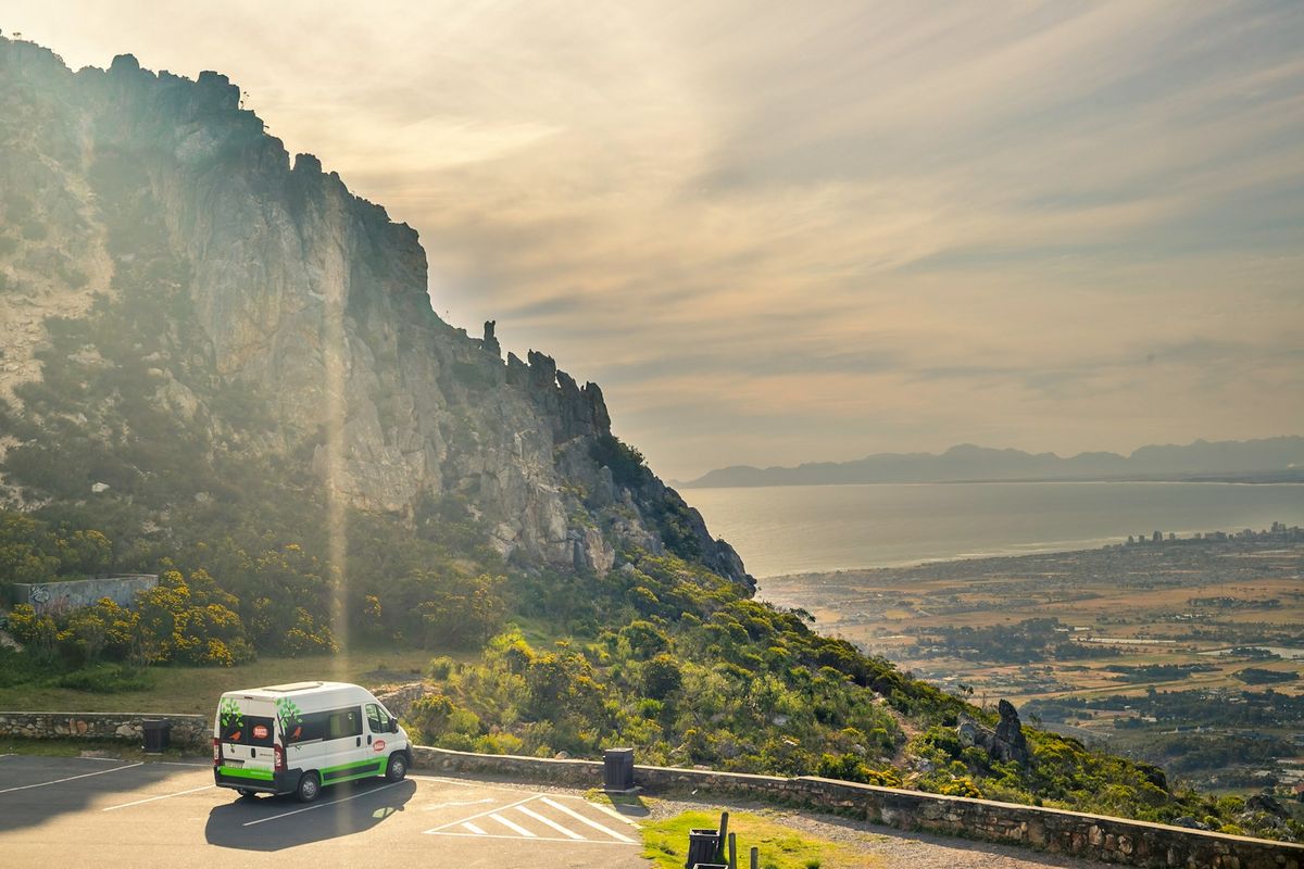 Coach bus on a scenic coastal cliff road in South Africa