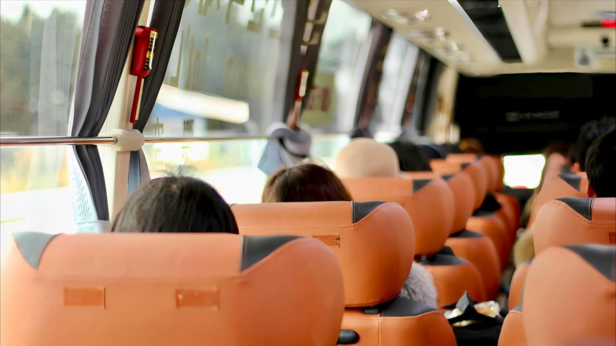 Passengers looking out of coach bus windows