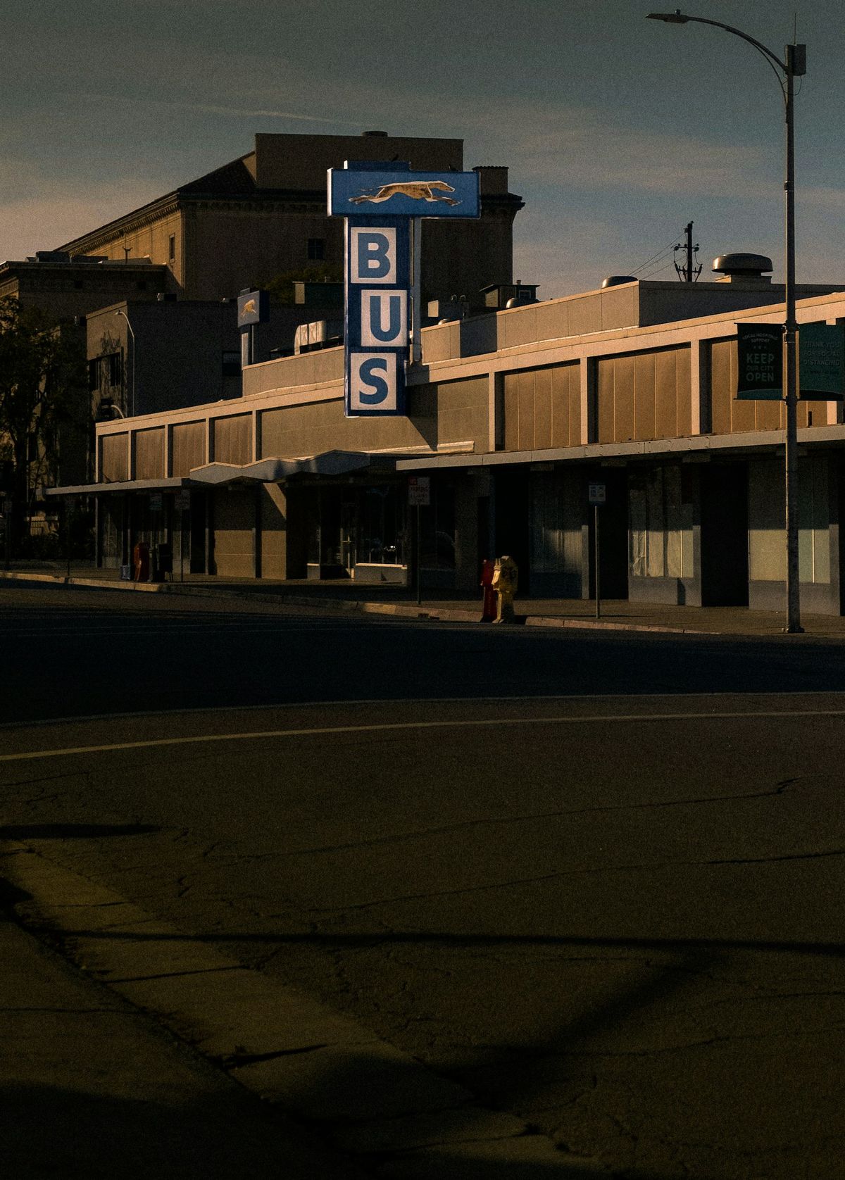 Greyhound bus sign at a roadside stop