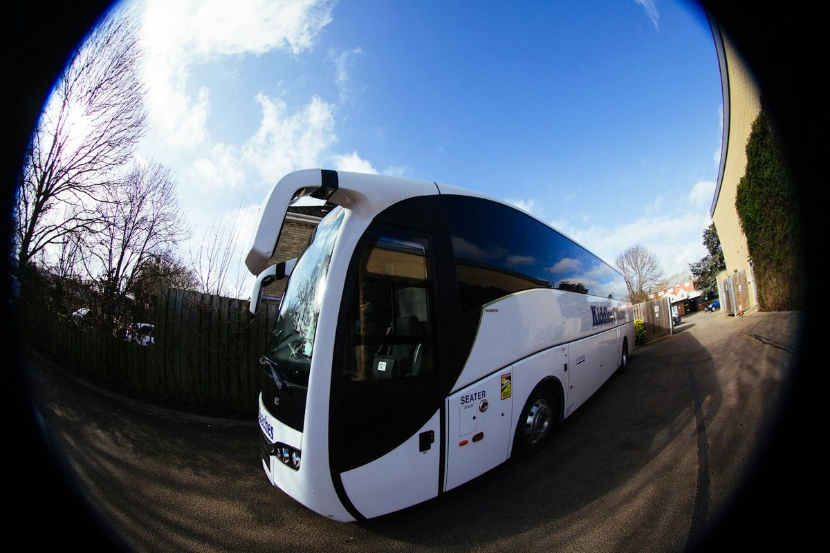 White long-distance coach bus parked outdoors