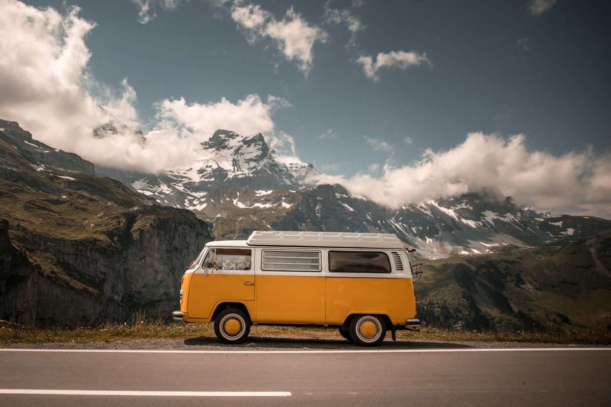 White van on a winding alpine road at Klausenpass in Switzerland