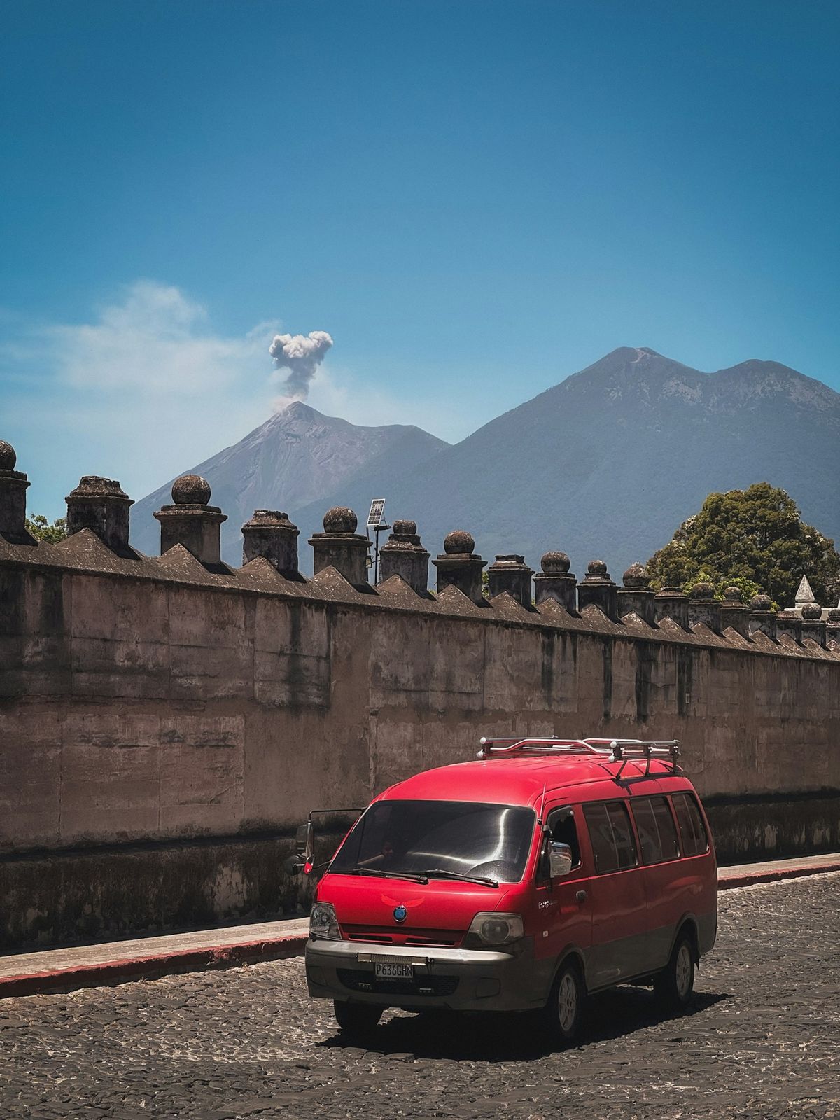 Tourist shuttle van with a volcano in the background, Central America