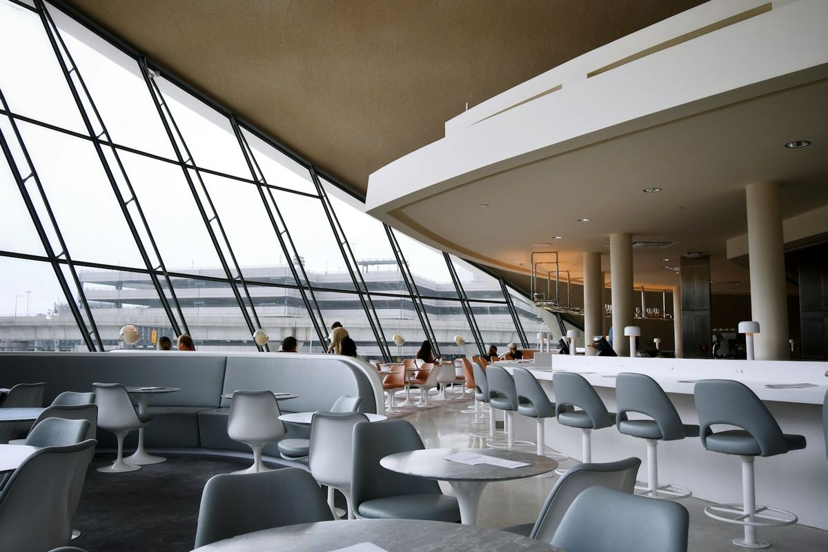 Airport lounge seating area with large windows