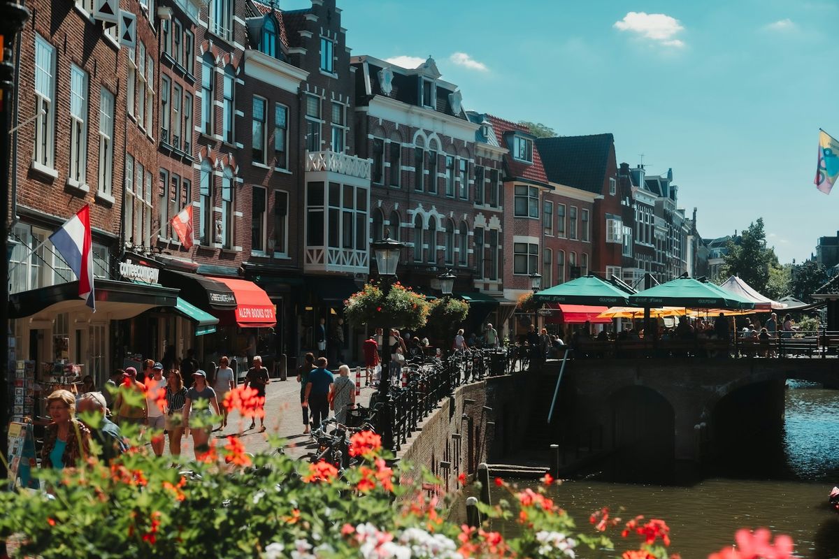 Tourists walking across a bridge sightseeing in a European city