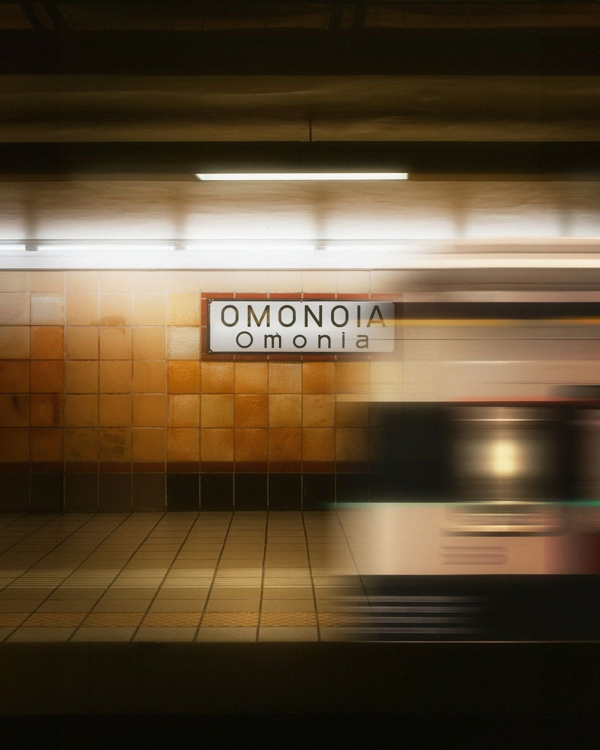 Blurred Athens Metro train passing through Omonoia station