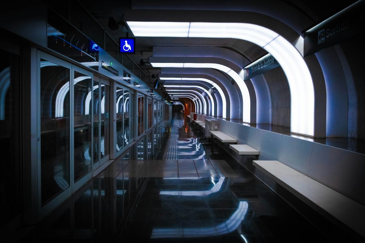 People walking inside a Barcelona metro station