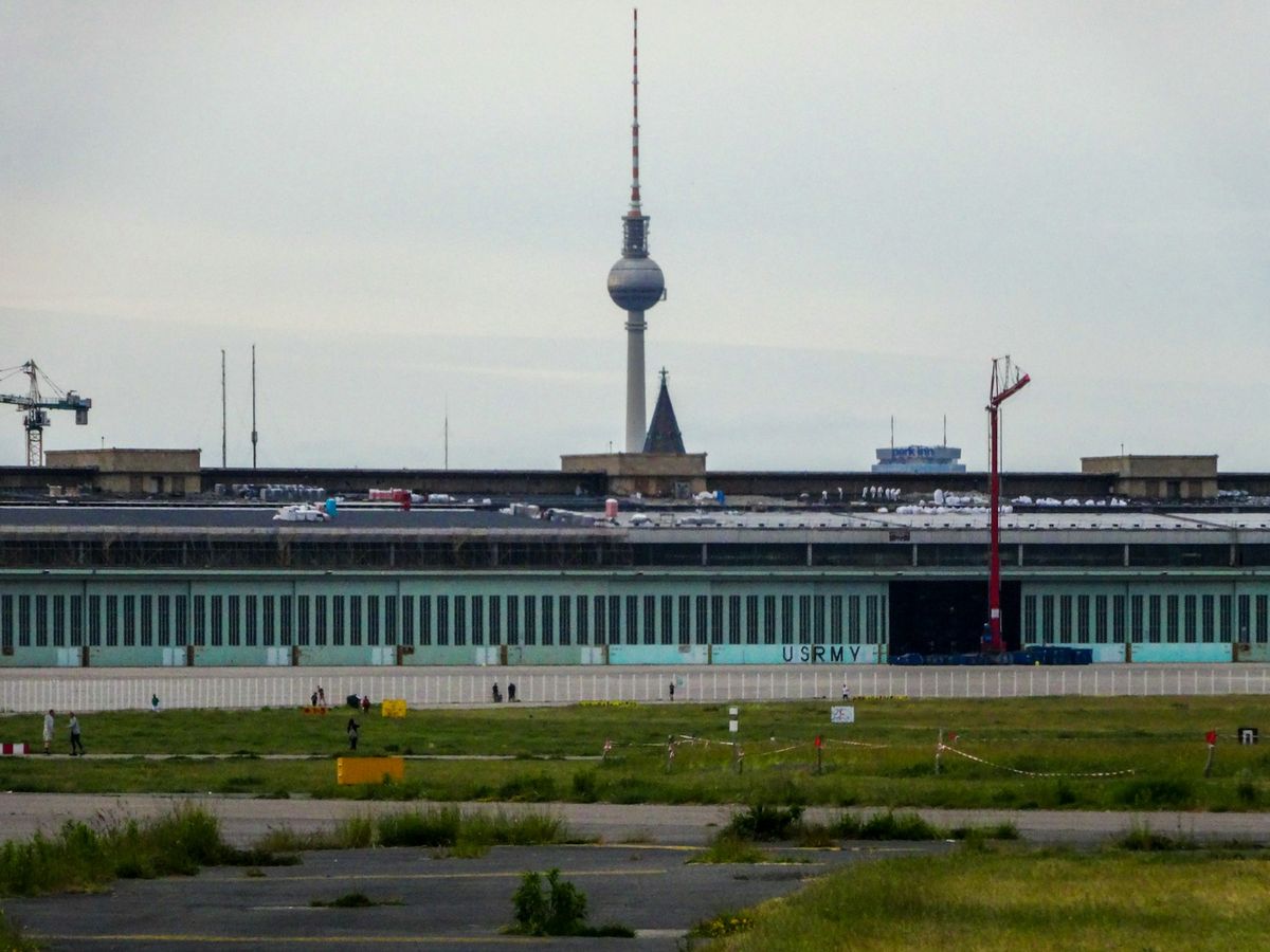 Modern BER airport terminal with Berlin TV tower in background