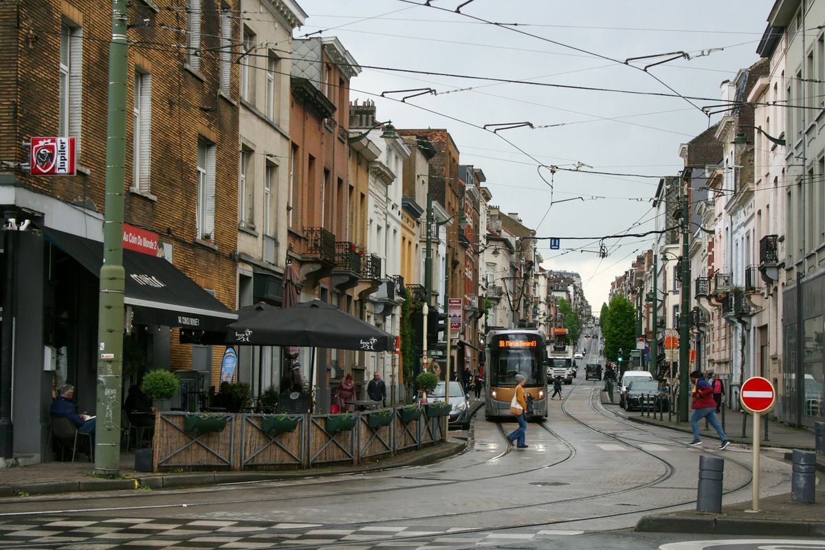 Brussels tram on a city street with historic buildings