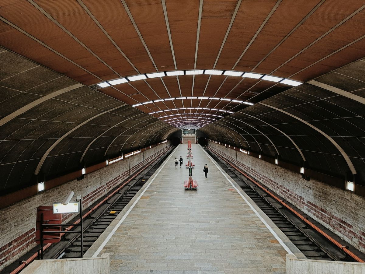 Train station platform with people walking in Bucharest metro