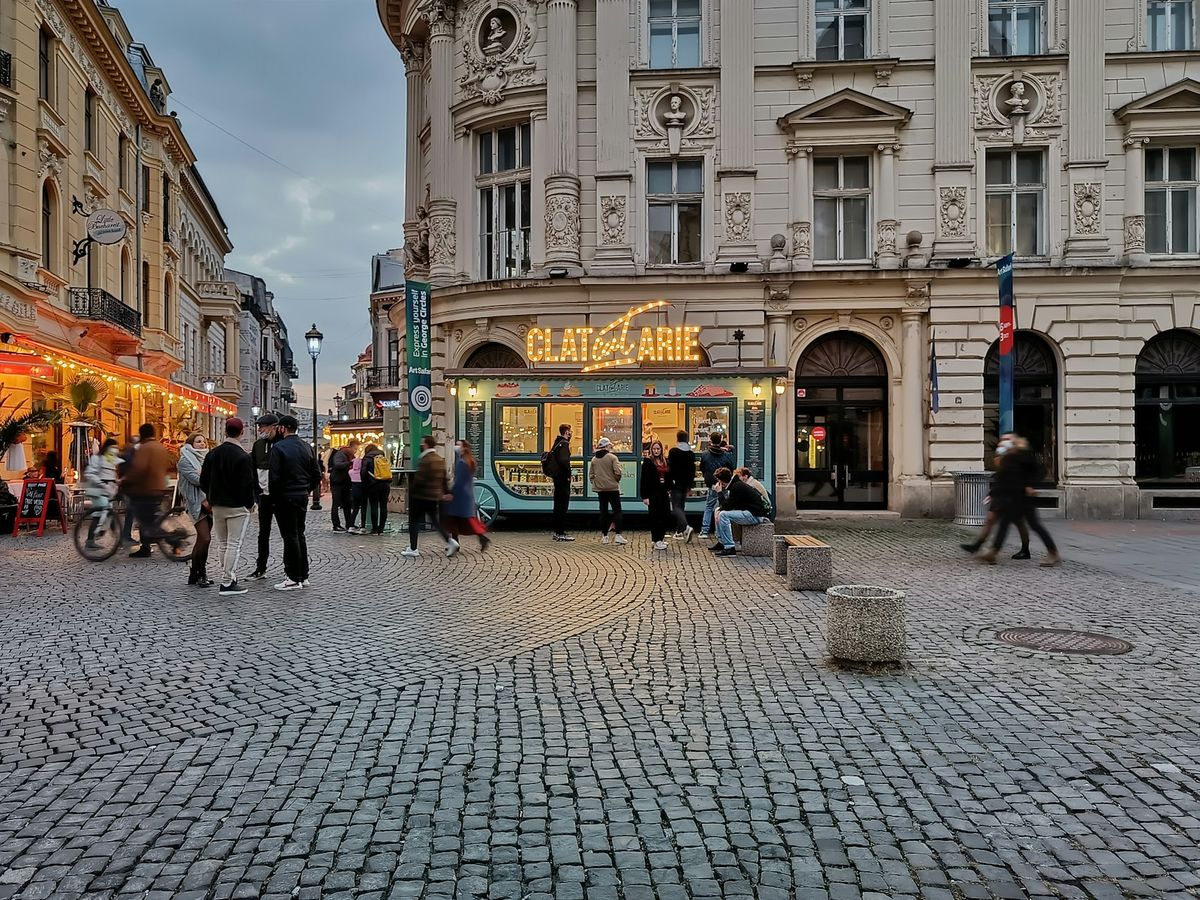 Cobblestone street in Bucharest old town with people walking