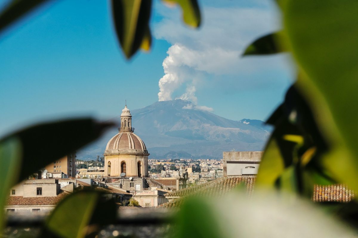 Catania's cityscape with Mount Etna rising behind it