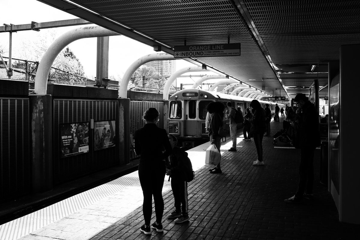 People waiting for a train at a Boston MBTA station