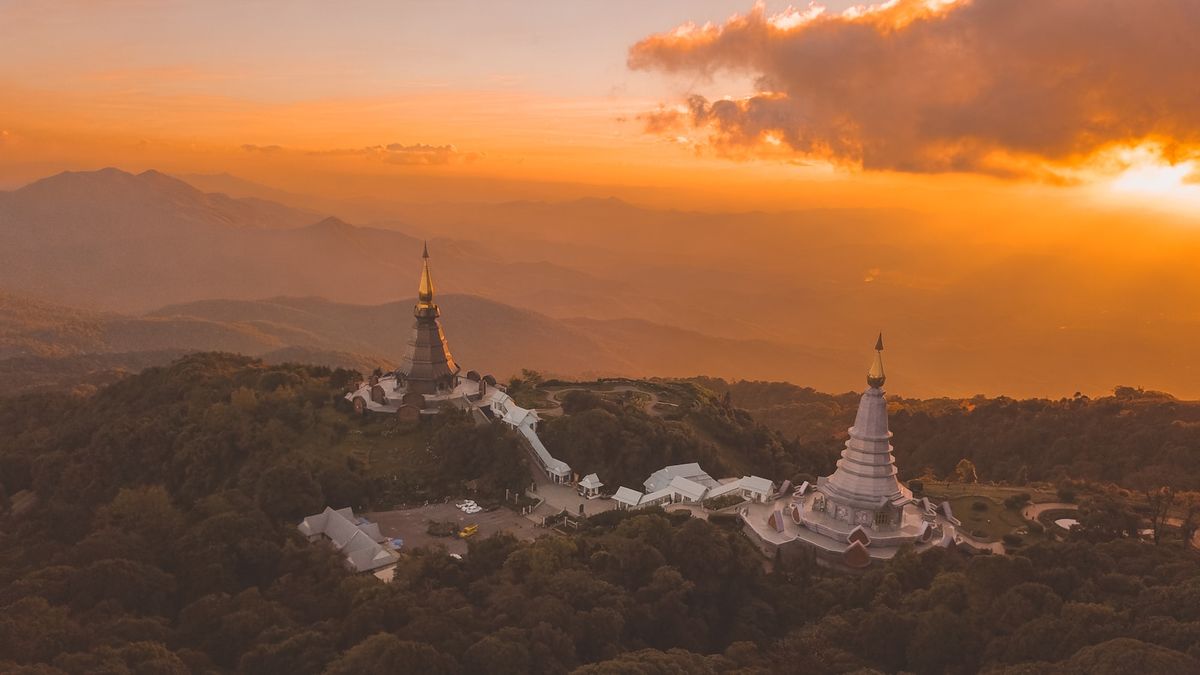 Bird's eye view of golden temple monuments in Chiang Mai during golden hour