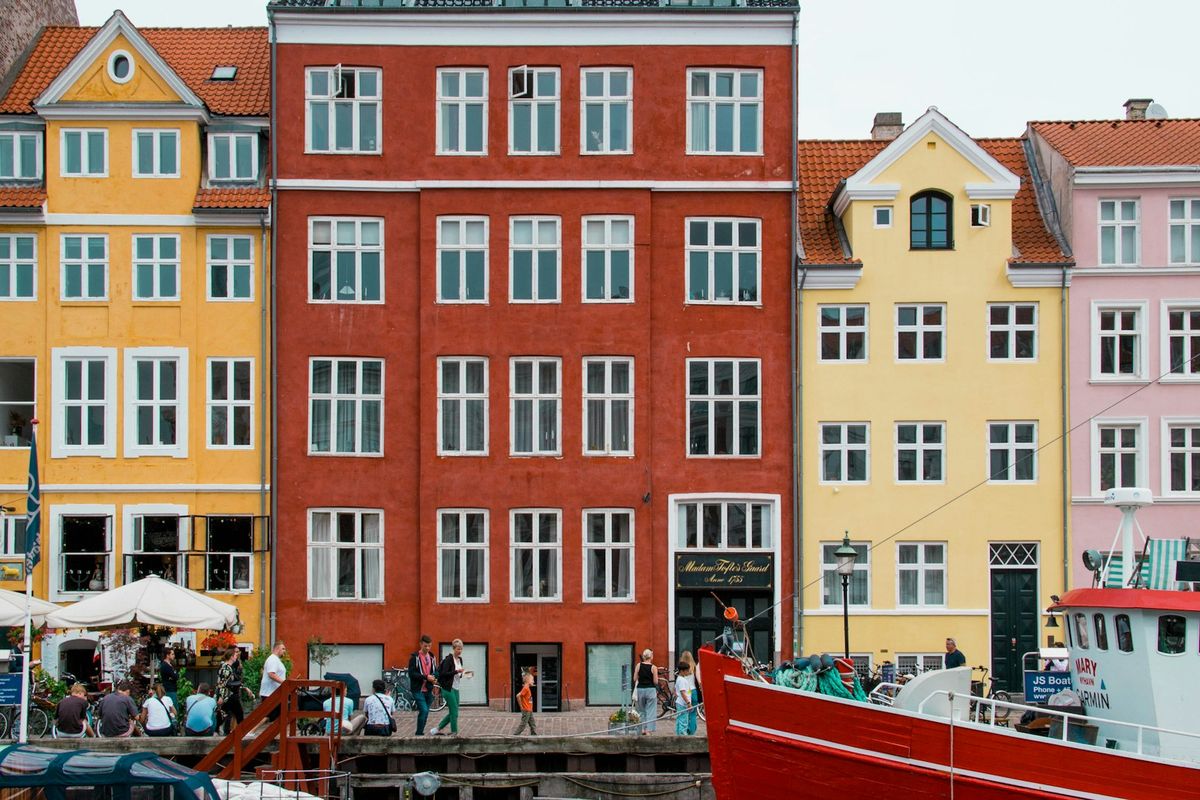 Red boat moored in front of colourful houses at Nyhavn, Copenhagen