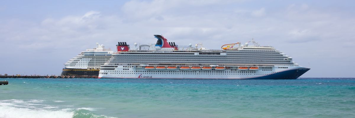 Cruise ship docked at pier in Cozumel Mexico with turquoise Caribbean sea